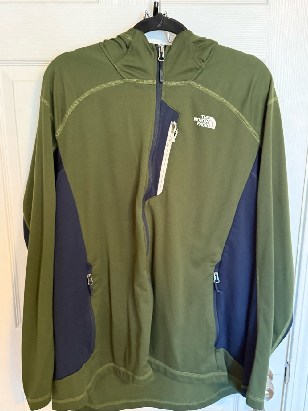 North face zip up. Green and blue. Multiple pockets.